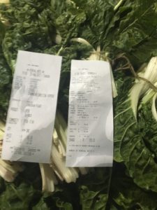 Photo of purchase slips on top of spinach sample